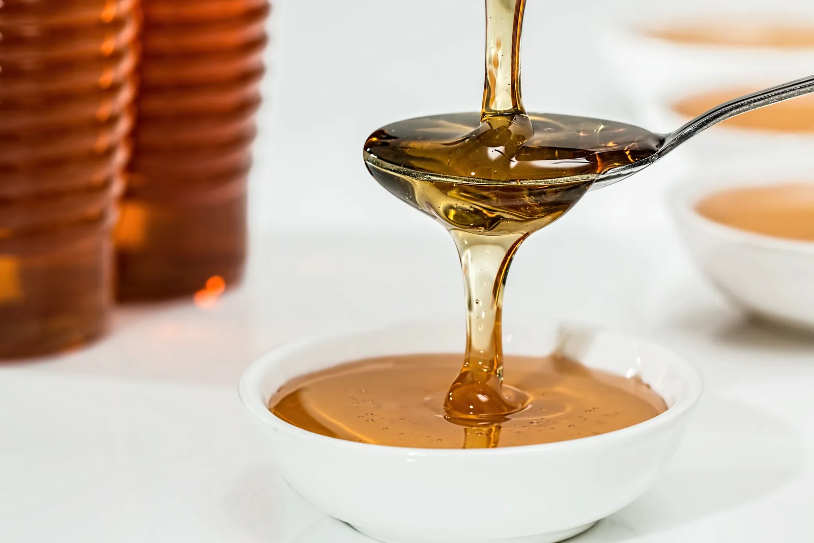 Honey being poured into a bowl